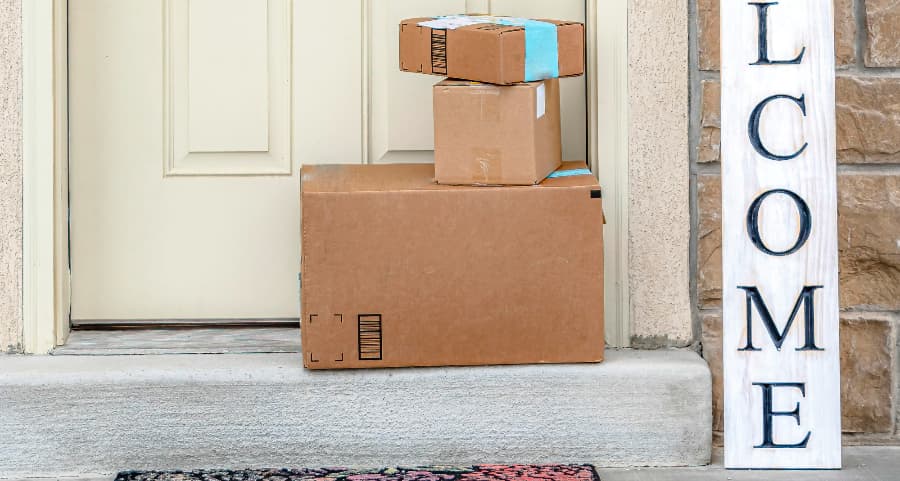 Packages on the doorstep of a home with a welcome sign in Napa